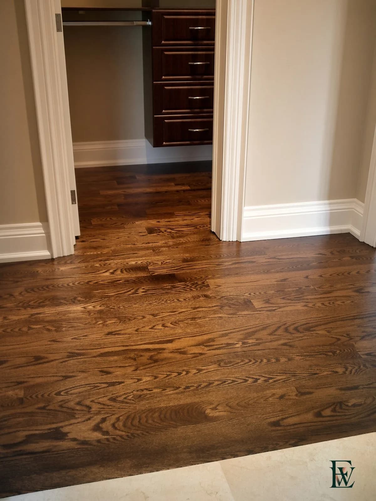 Oak hallway floor running through a closet door casing, frame 1 of 3, full hallway view, Ecowoods site work, Toronto.