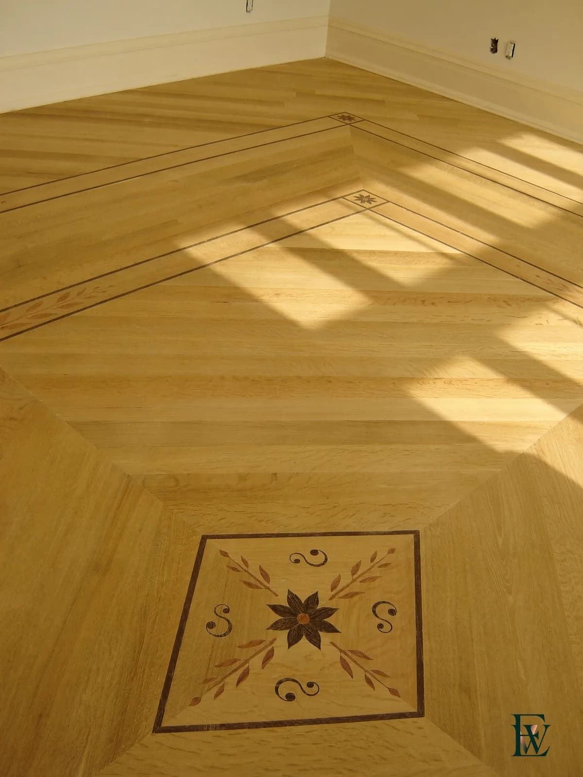 Floral medallion inlay set into an oak field floor, frame 1 of 3, standing room view, Ecowoods site work, Toronto.
