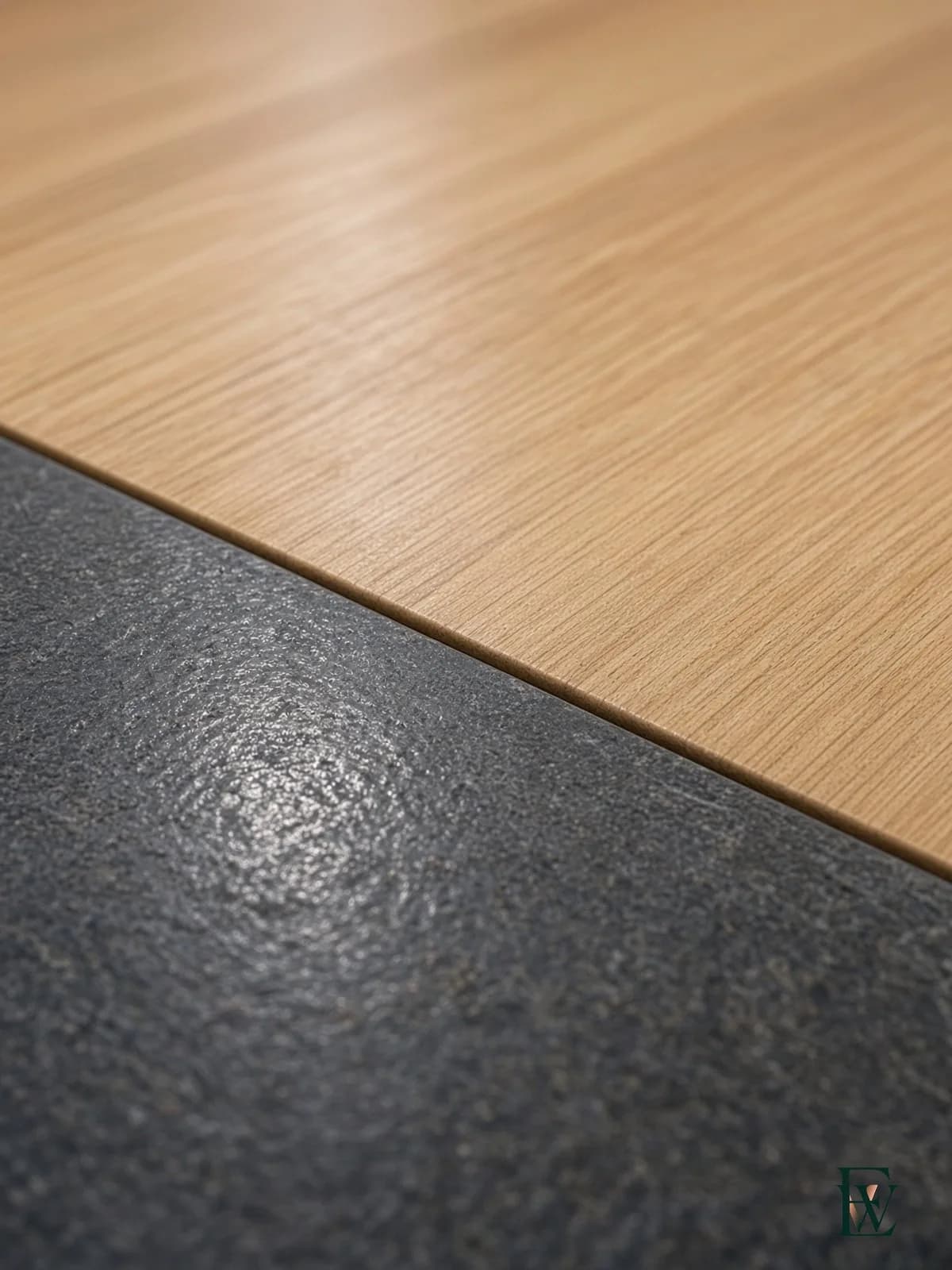 Hardwood retail floor at a mall threshold, frame 3 of 3, macro of the cut where mall tile meets hardwood with no trip edge, Ecowoods site work, Toronto.