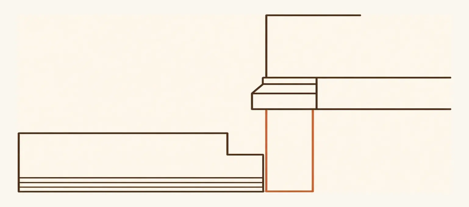 Detail cross-section at a wall showing the gap left between the last floorboard and the wall, concealed beneath the baseboard.