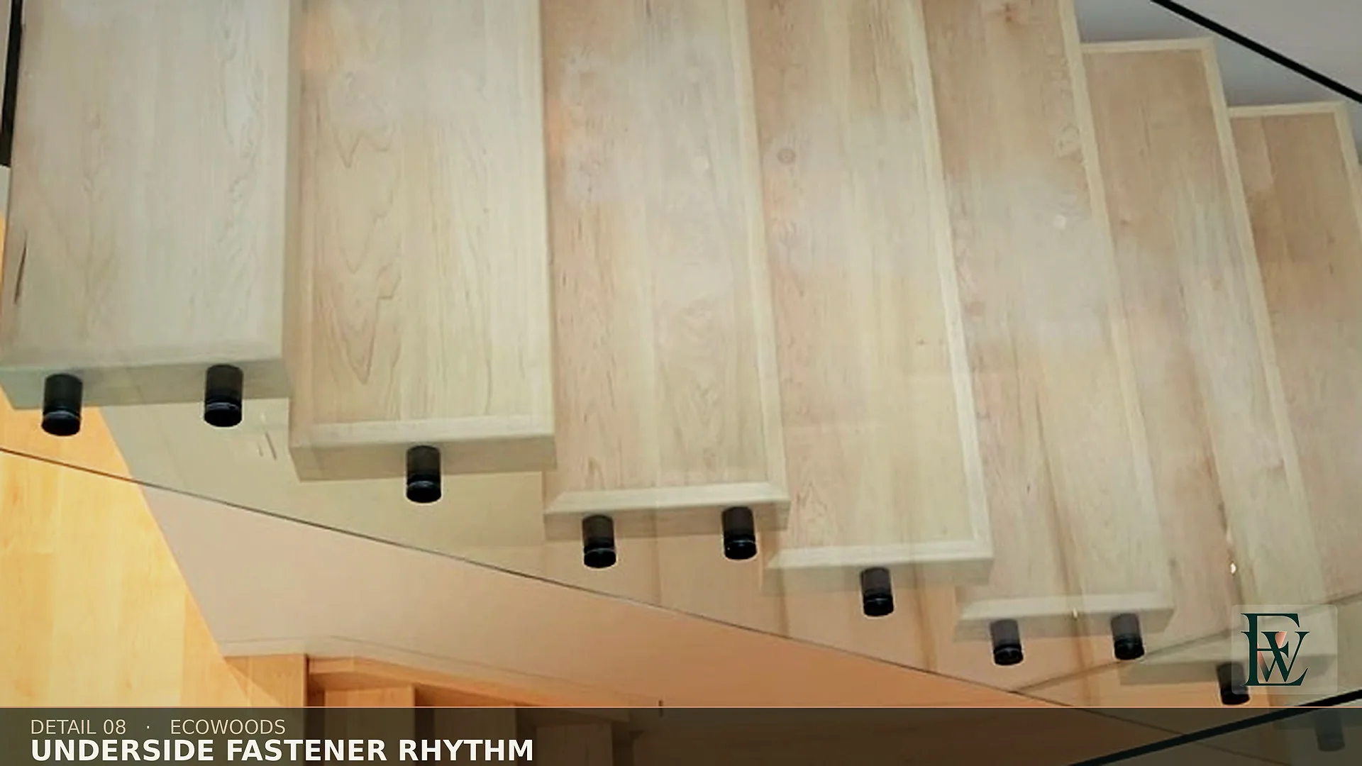 The finished underside of an open-riser flight, fasteners set on a single visible line.