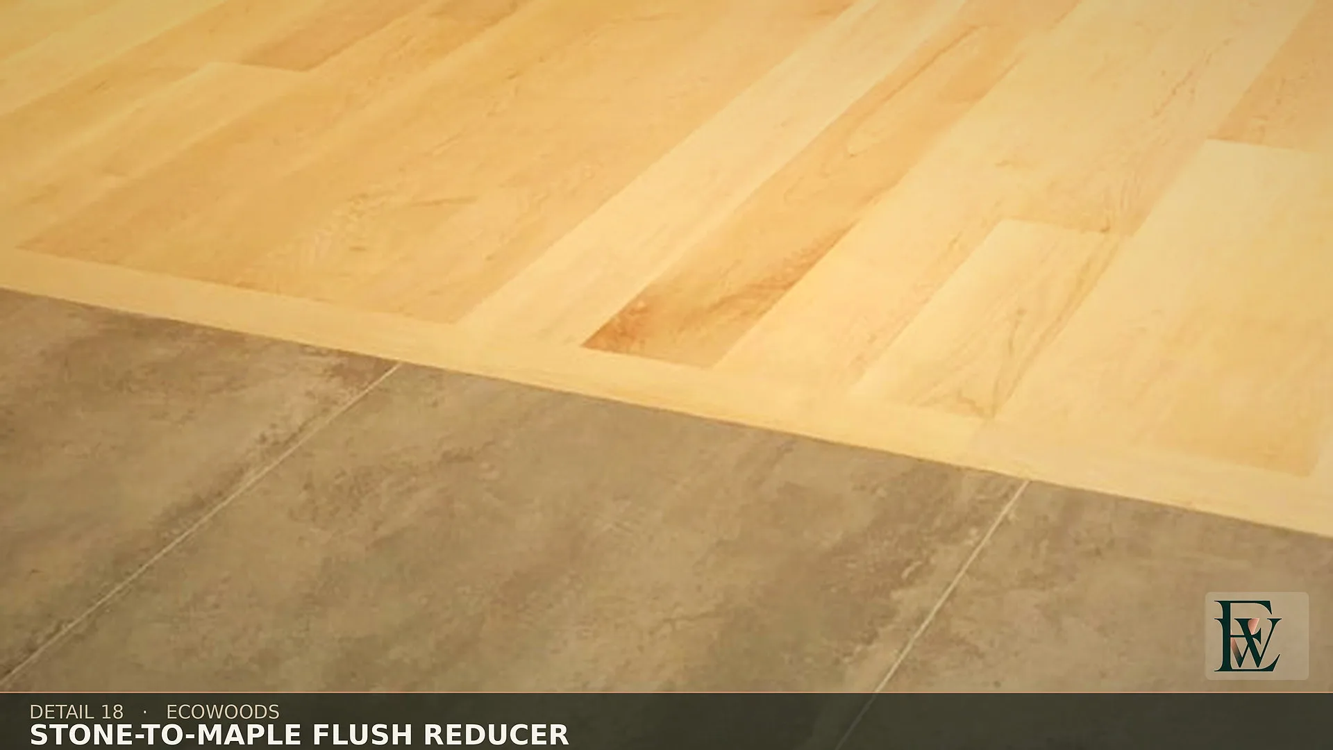 A flush reducer where hard maple meets stone tile on a single plane, with no ramp or lip.