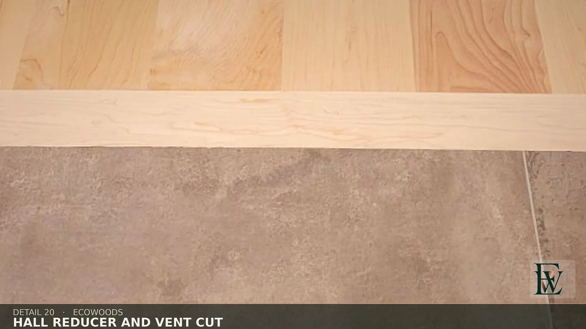 The same flush stone-to-maple reducer paired with a floor register cut that follows the board line.