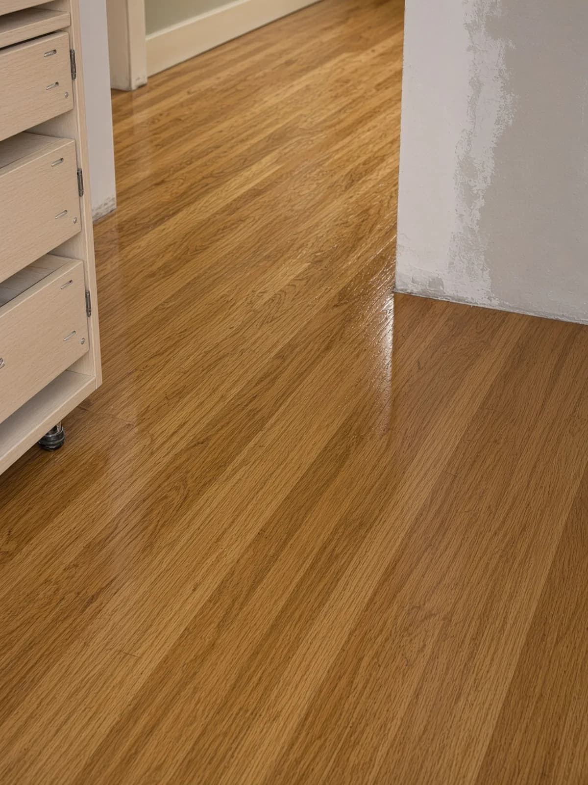 A completed floor against still-open drywall — the floor finished before the walls.